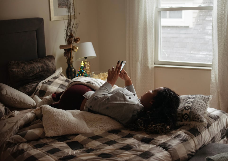 A-woman-watching-television-and-eating-popcorn-how-to-overcome-social-isolation