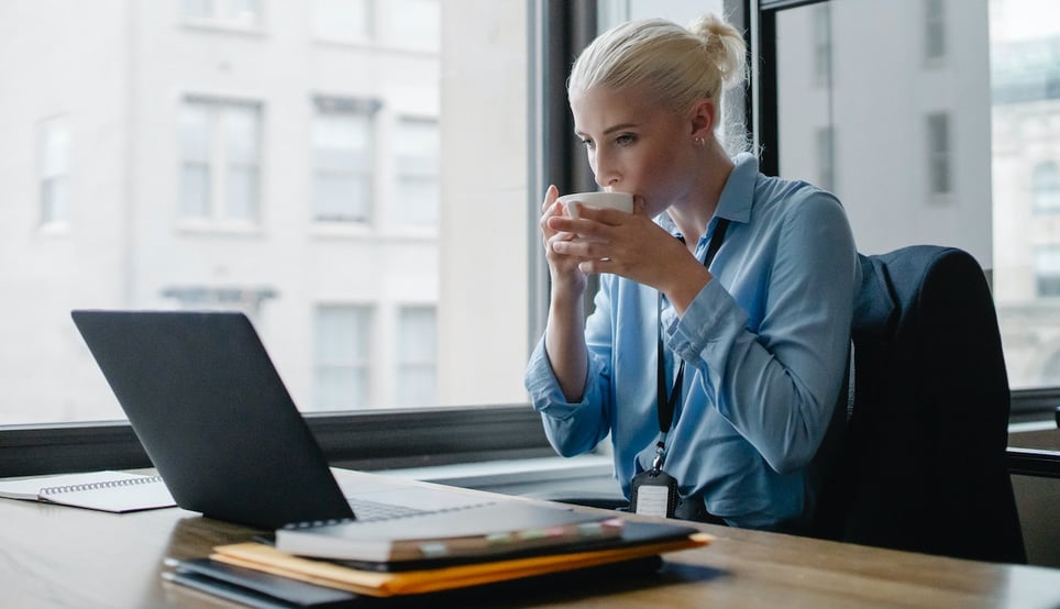 Business-woman-at-office-with-coffee-cuporking-on-laptop-ethical-values