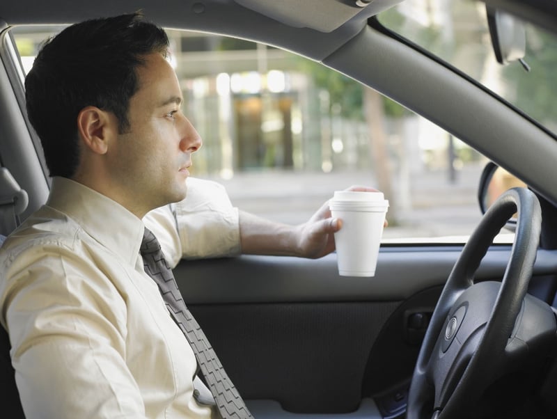 Businessman-driving-and-drinking-coffee-why-am-i-so-tired-all-the-time-1