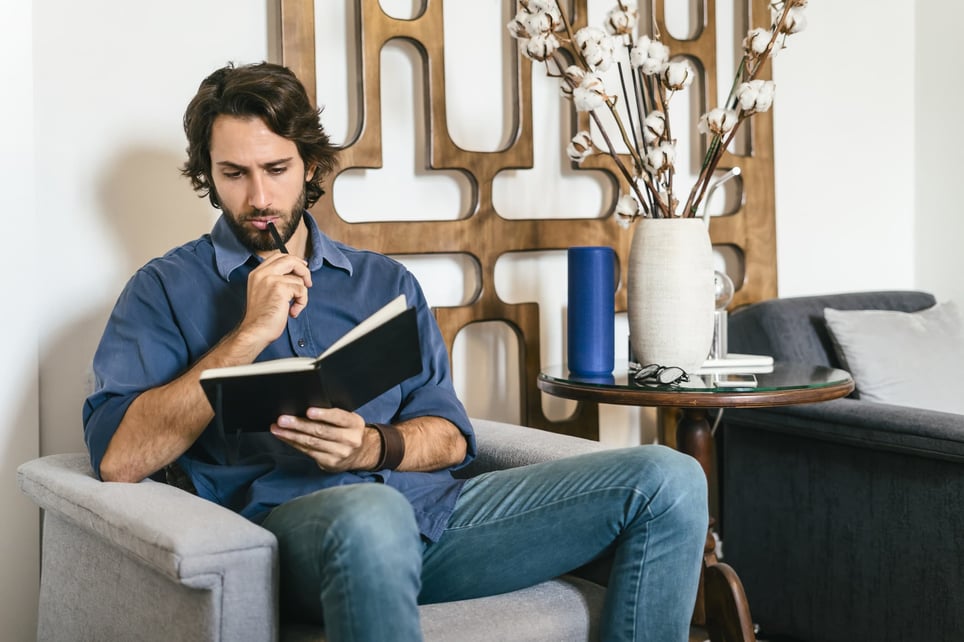 Businessman-looking-at-notebook-and-thinking-how-to-hold-yourself-accountable