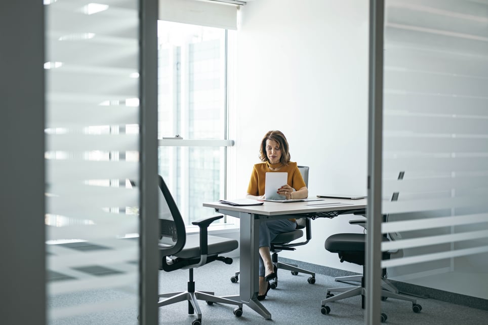 Businesswoman-Working-At-Her-Office-what-is-the-open-door-policy-workplace