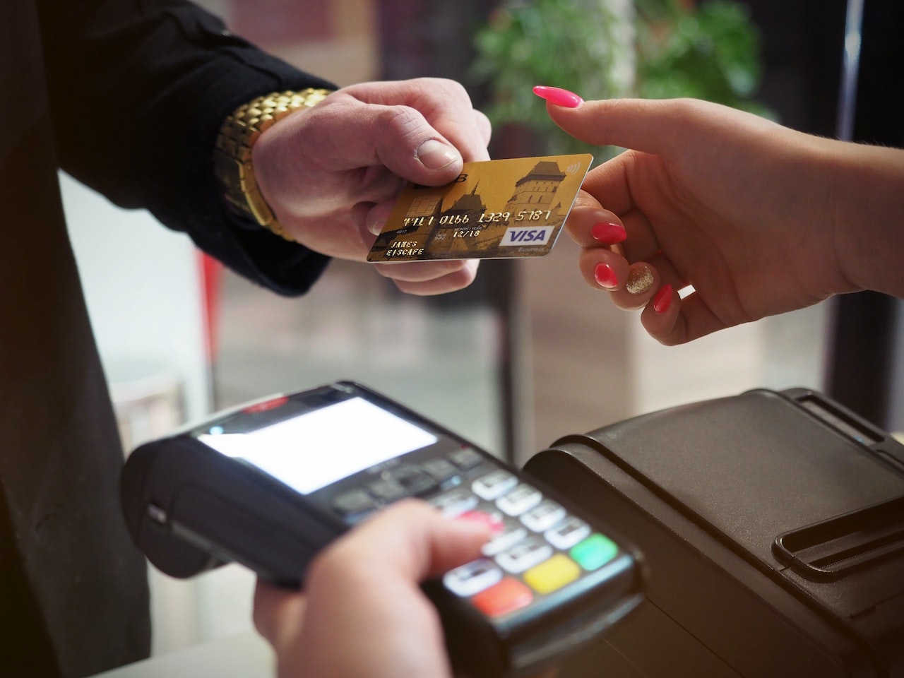 Close-up-of-man-handing-his-credit-card-to-cashier-life-skills-for-adults