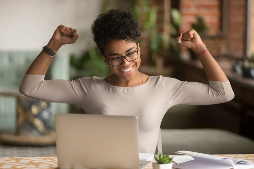 Excited-woman-working-from-home-how-to-be-ambitious