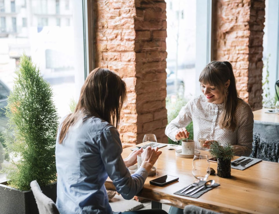 Friends-Enjoying-Meeting-At-Cafeteria-1