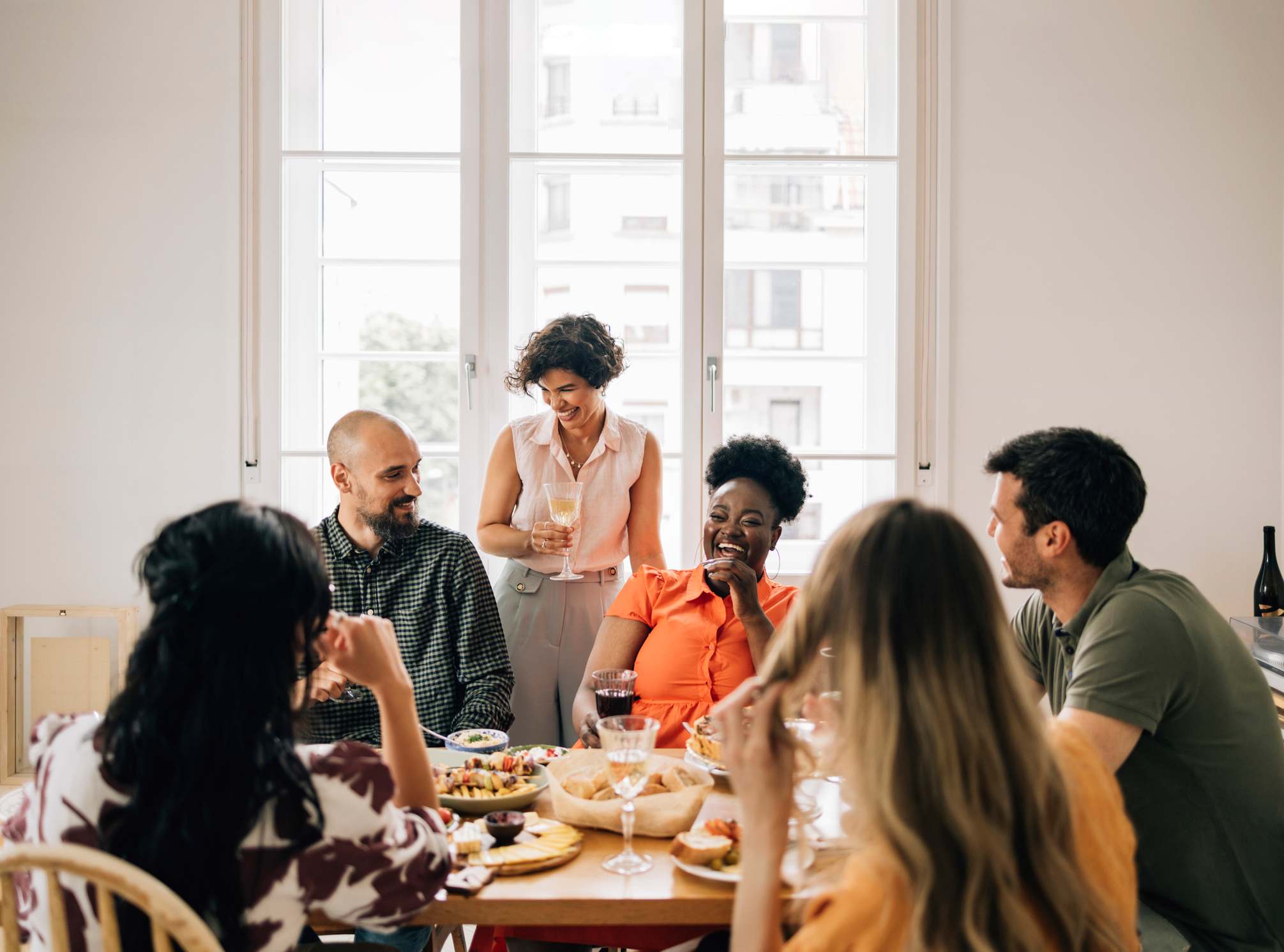 Group-of-friends-talking-and-laughing-at-lunch-how-to-improve-self-determination