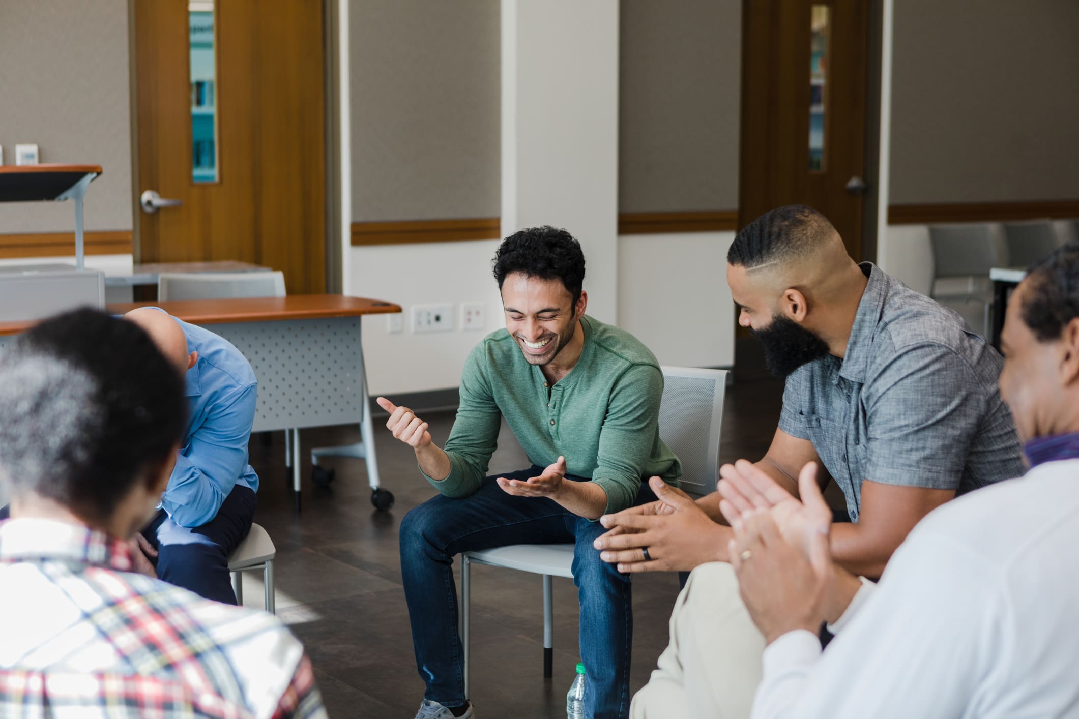 Group-of-people-sharing-a-happy-therapy-session-how-to-protect-yourself-from-toxic-empathy