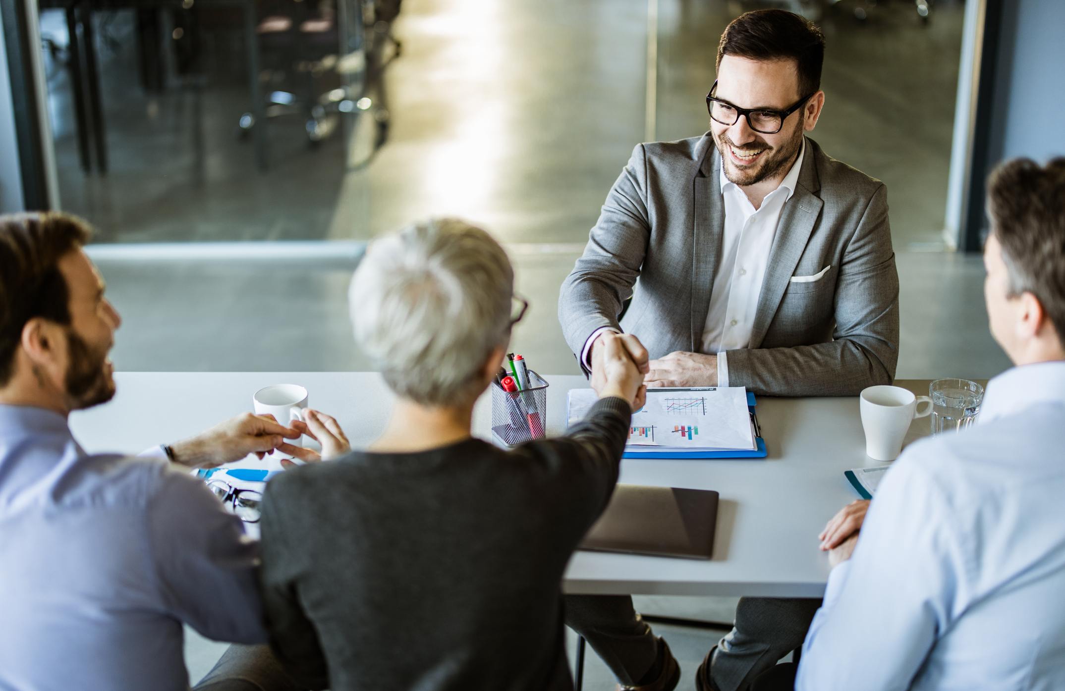 Happy-businessman-shaking-hands-with-member-of-human-resource-team-in-the-office-best-job-posting-sites-for-employers-3