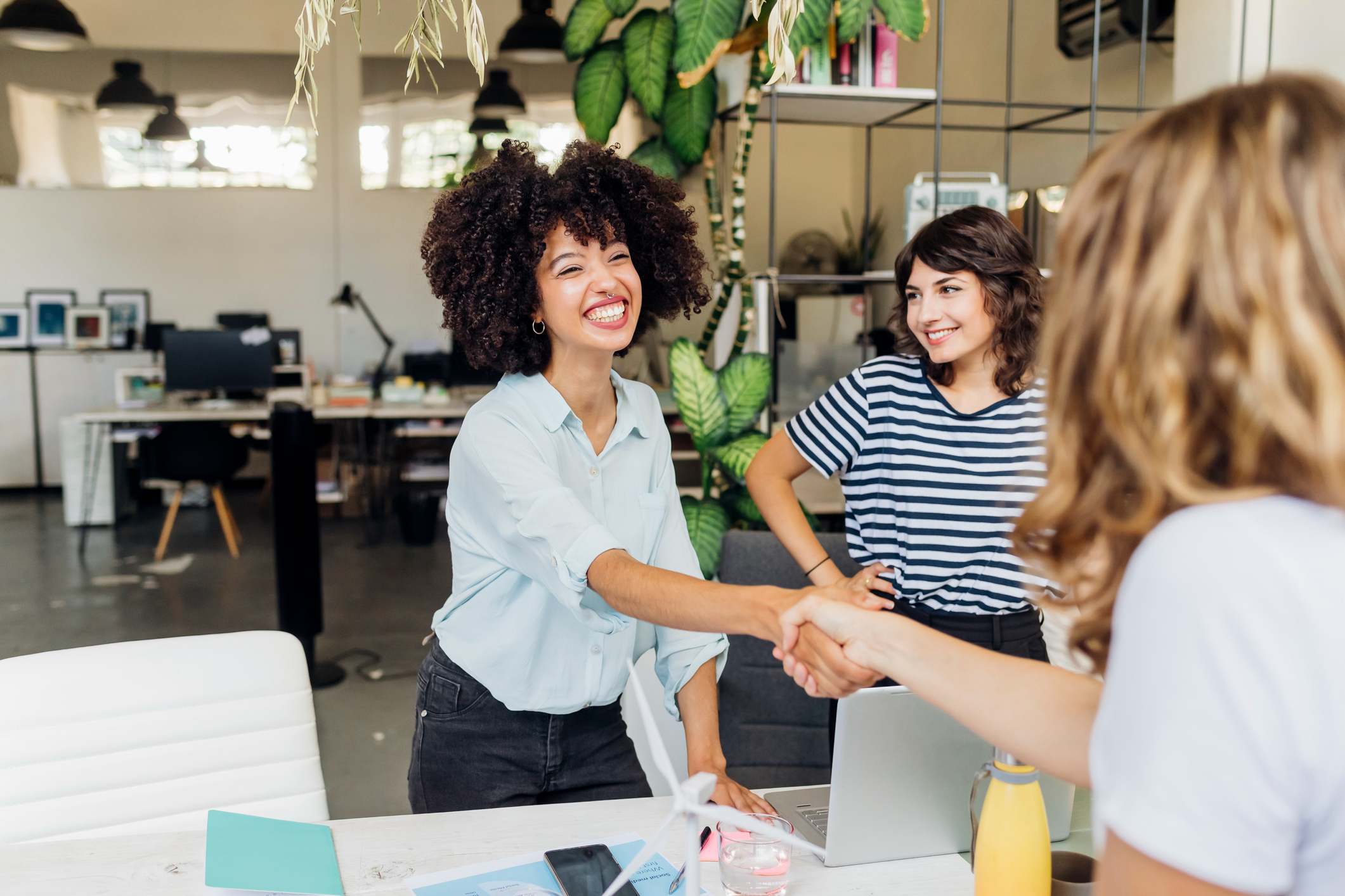 Happy-businesswoman-shaking-hand-with-colleague-at-work-place-bad-at-job-interviews