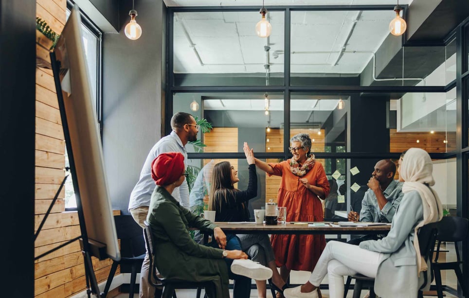Happy-employees-at-their-office-giving-high-fives-employee-health