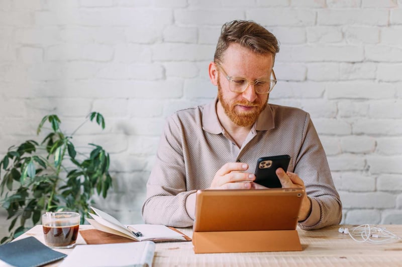 Man-Texting-And-Smiling-how-to-cold-connect-on-Linkedin