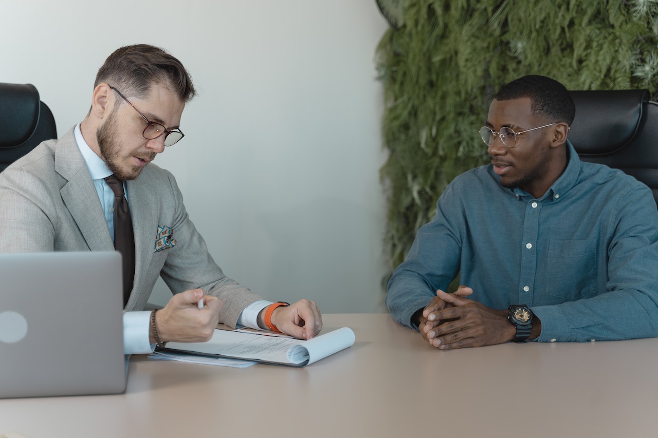 Man-at-job-interview-looking-at-recruiter-words-to-describe-yourself