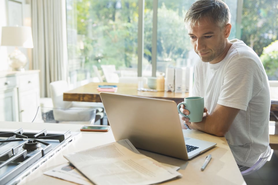 Man-drinking-from-a-mug-working-from-home-work-from-home-policy