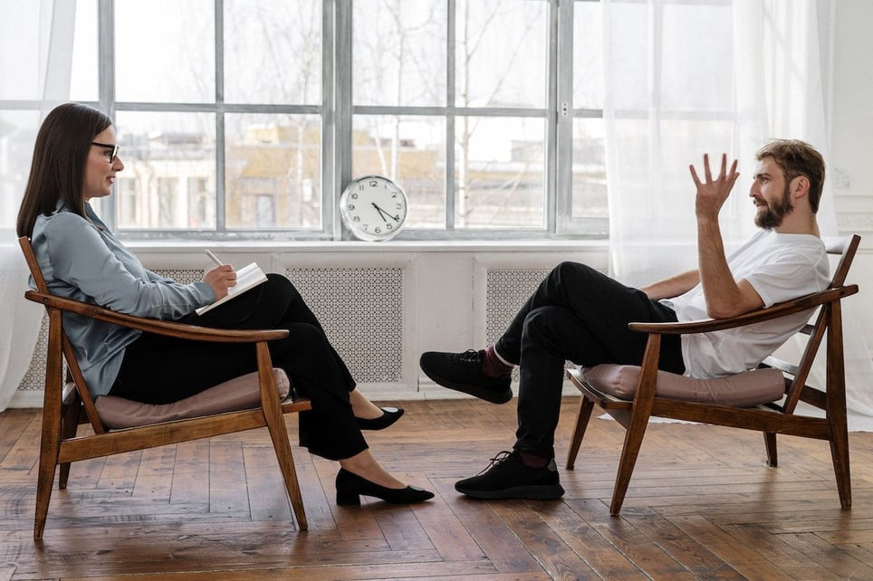Man-in-therapy-session-talking-to-therapist-psychology-degree-jobs