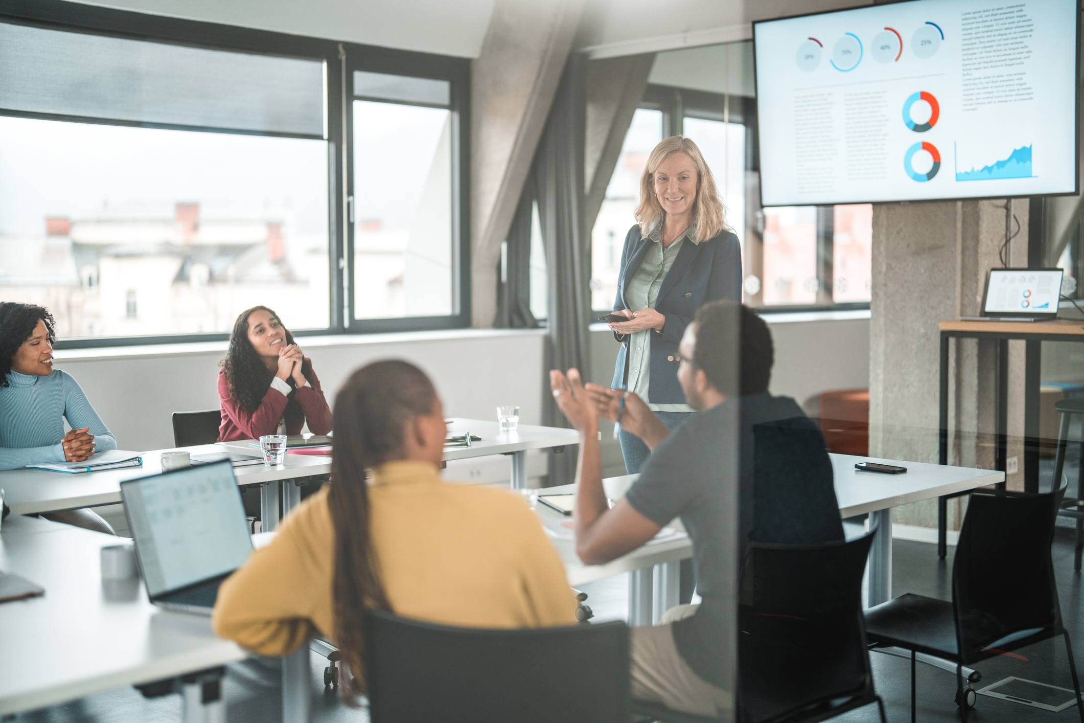 Man-talking-and-everyone-listening-at-eam-meeting-how-to-stop-micromanaging