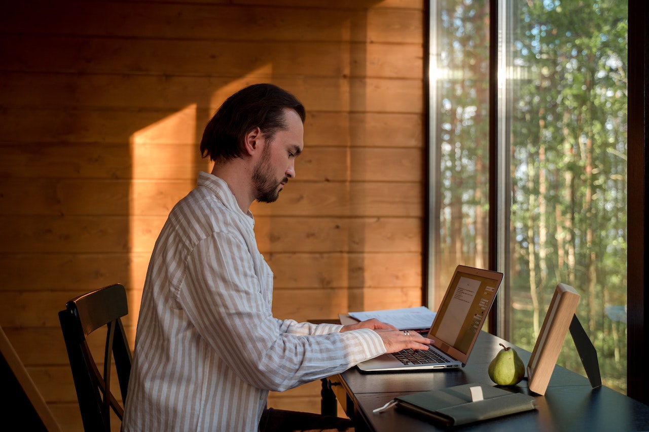 Man-writing-letter-on-a-laptop-resignation-letter