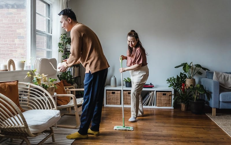 Married-couple-cleaning-and-watering-plants-together-at-home-life-skills-for-adults