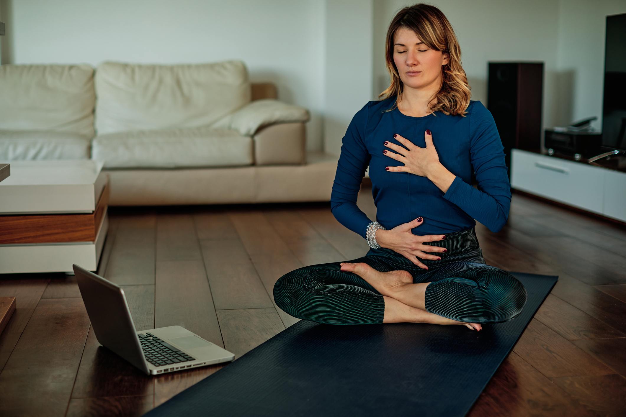 Middle-aged-brunette-sitting-in-lotus-poses-mindfulness-vs-meditation