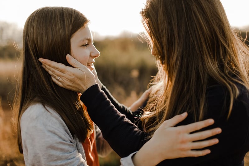 Mom-Holding-Daughters-Face-In-Her-Hands-types-of-nonverbal-communication