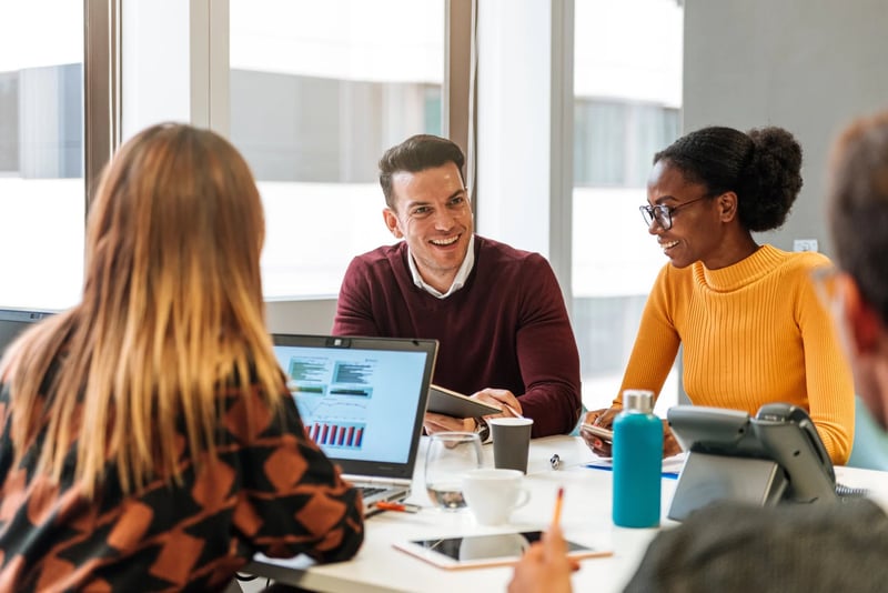 Office-Employees-At-Conference-Desk-Chatting-In-Office-how-to-ask-for-time-off