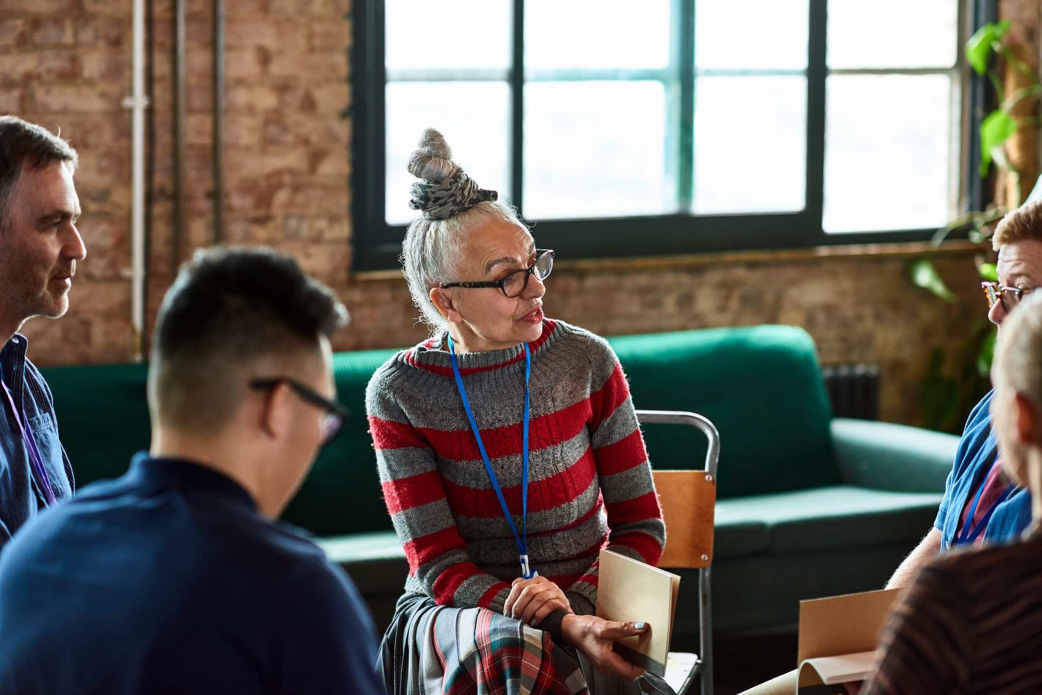 Old-woman-moderating-a-serious-debate-at-work-cognitive-empathy