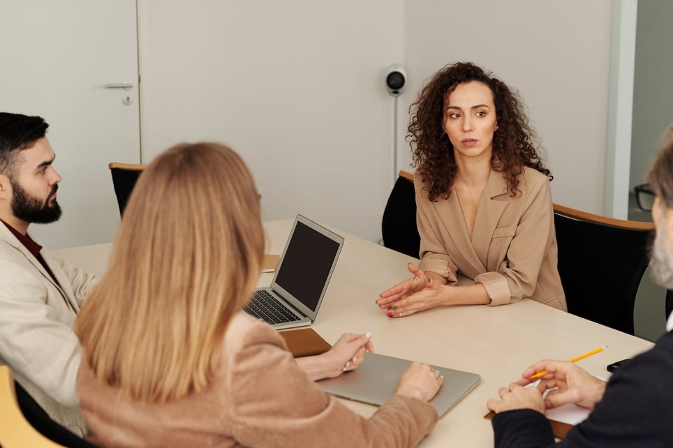 Serious-woman-at-meeting-with-employers-listening-carefully-voluntary-layoffs