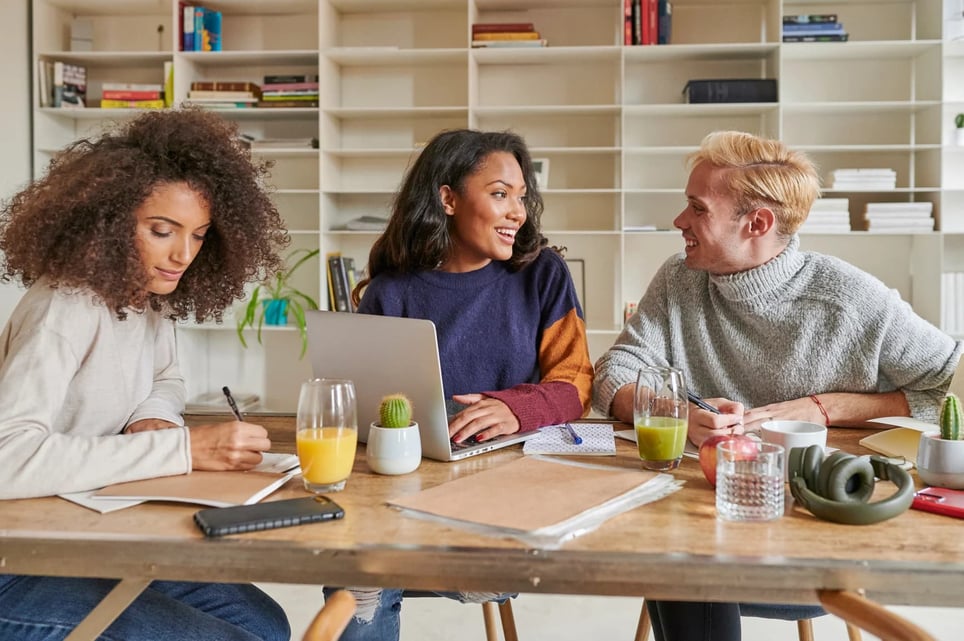 Smiling-group-of-young-people-working-together-around-a-table-Type-A-personality