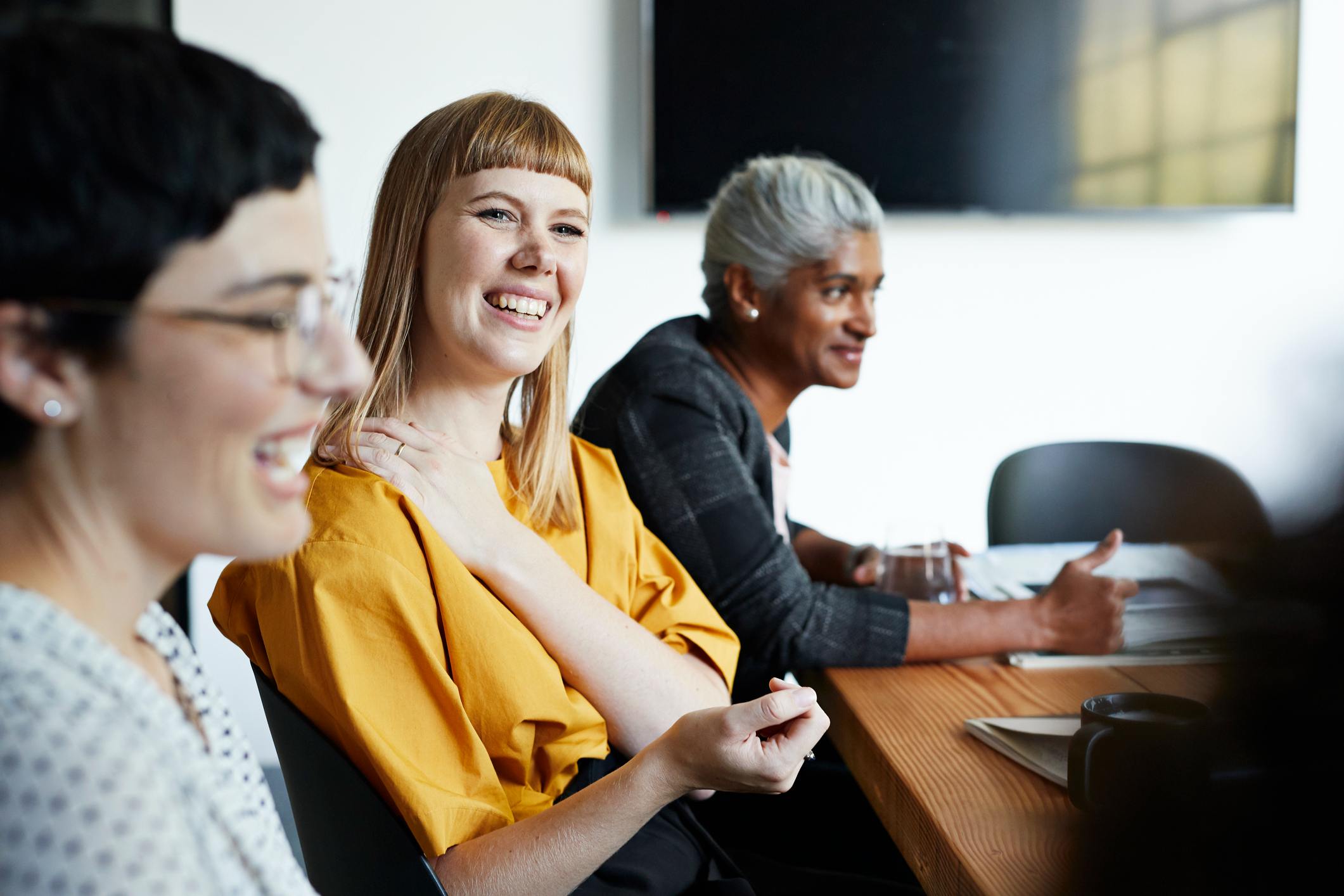 Smiling-woman-during-meeting-communication-styles-in-the-workplace