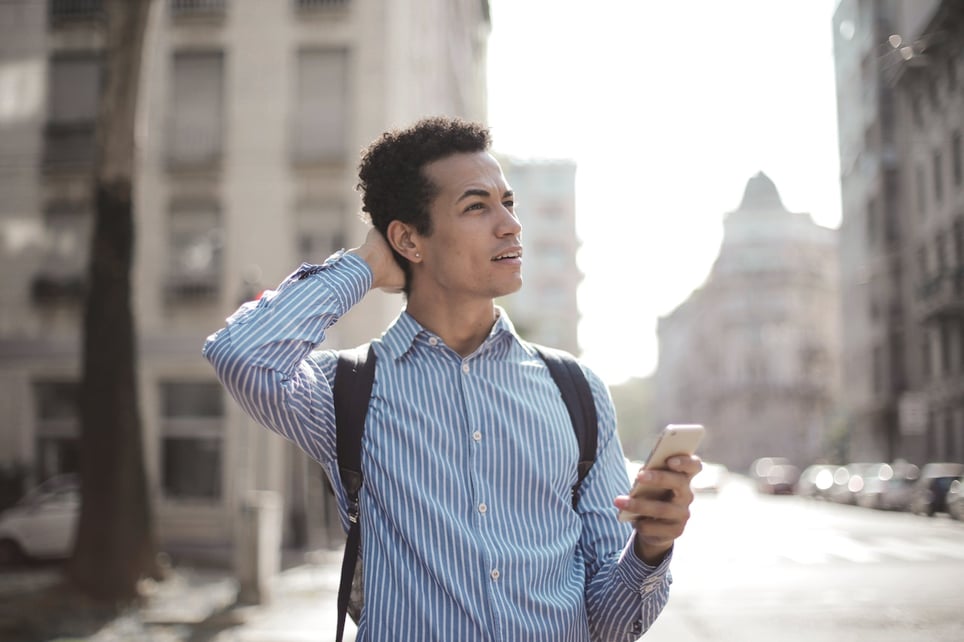 Stressed-man-outside-looking-at-his-phone-why-cant-i-keep-a-job