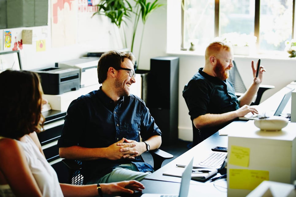 Three-happy-coworkers-laughing-together-in-their-office-cognitive-empathy