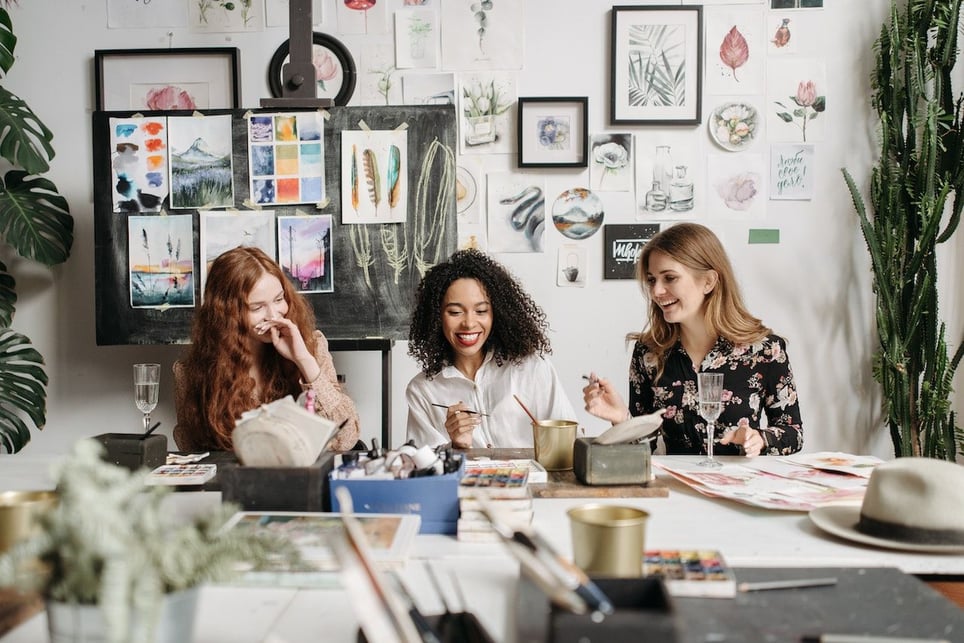 Three-woman-friends-painting-and-laughing-together-core-beliefs