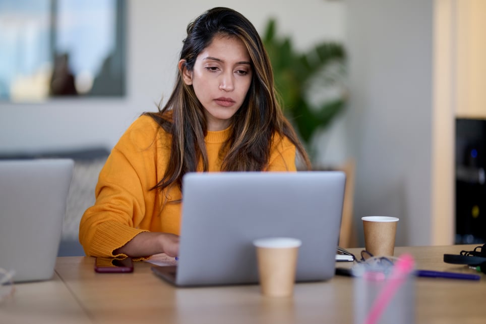 Tired-Businesswoman-Using-Laptop-In-Office-overworked-symptoms