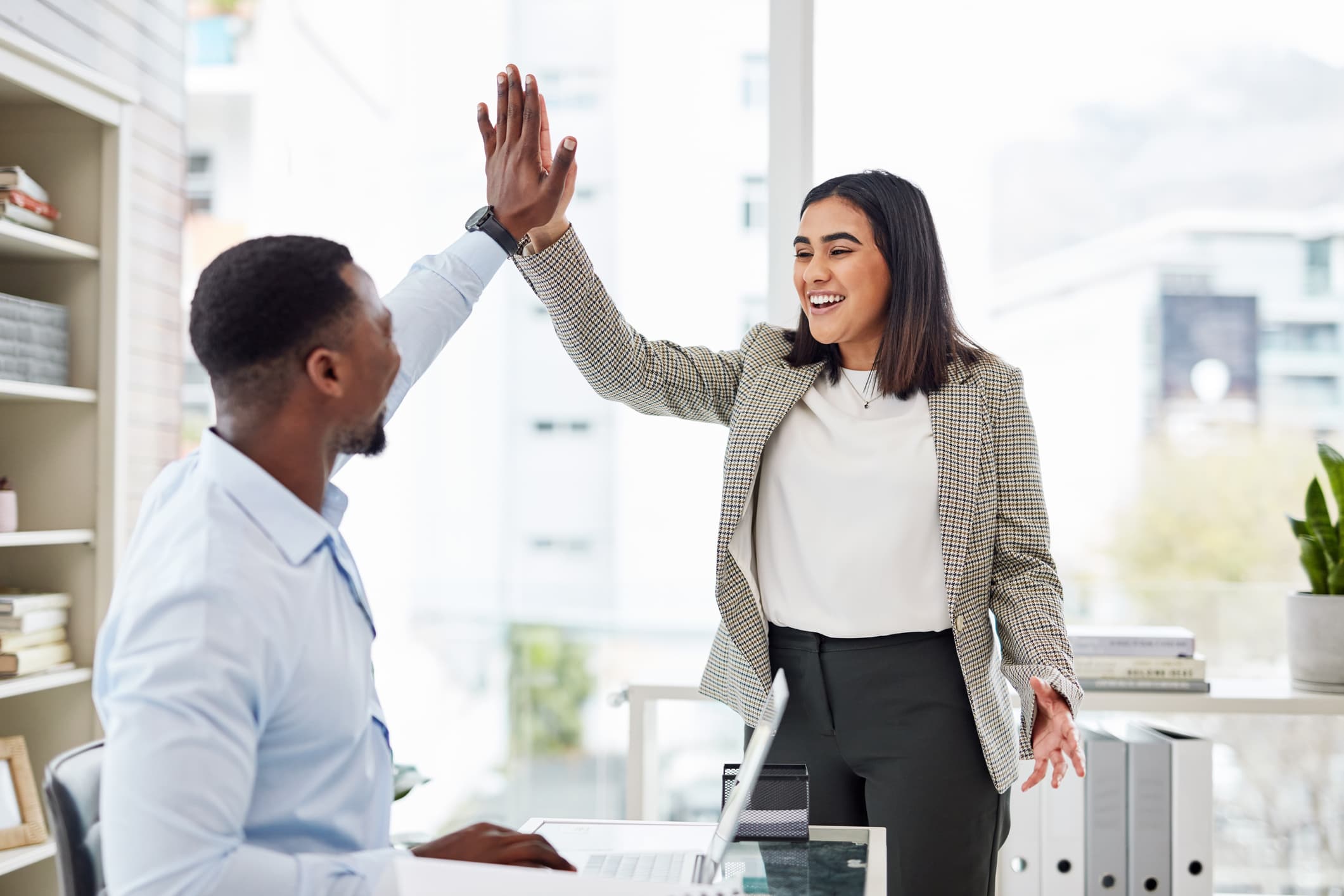 Two-businesspeople-giving-each-other-a-high-five-what-is-willpower