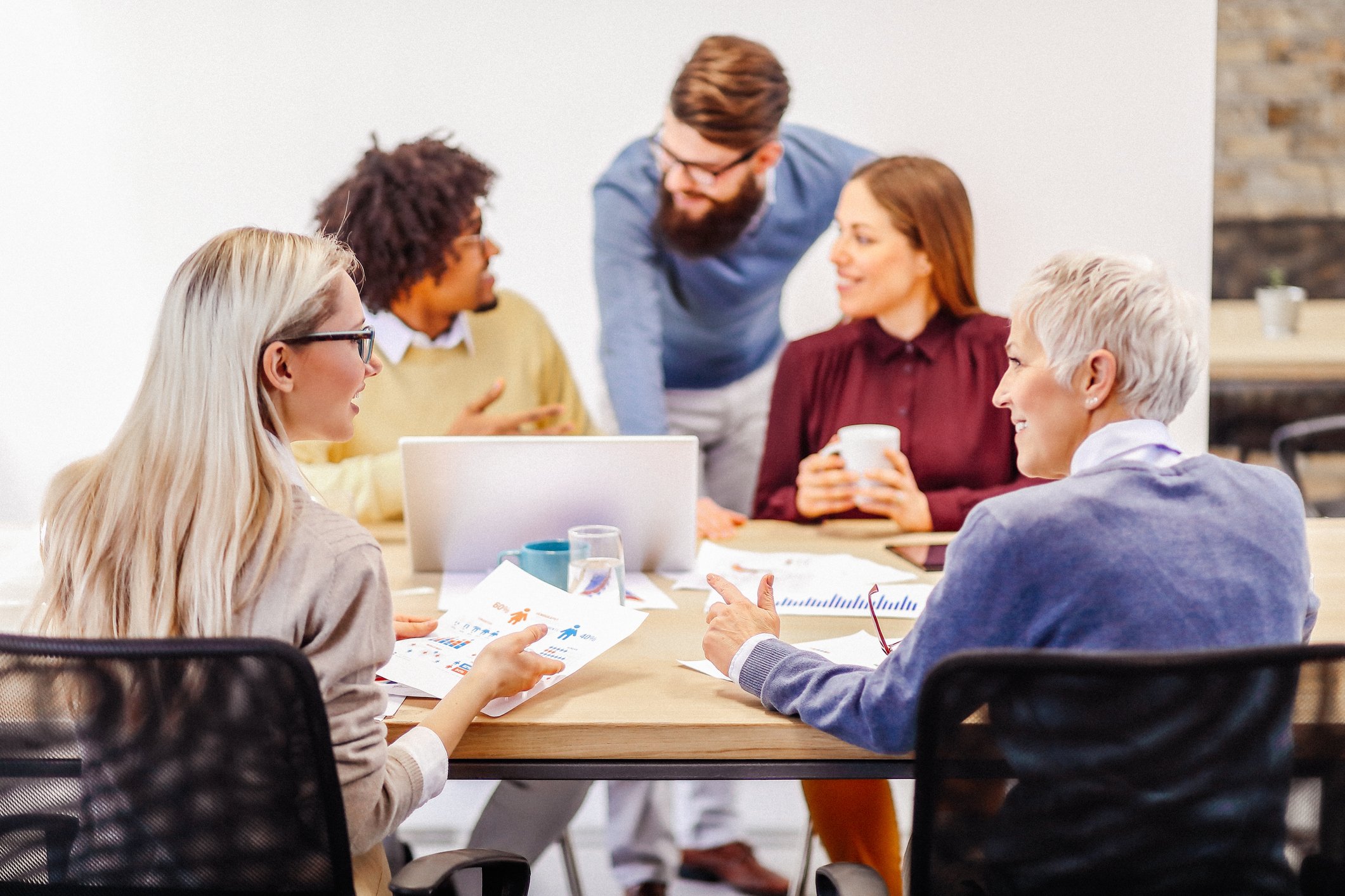 Two-collegues-talking-to-each-other-at-meeting-workplace-environments