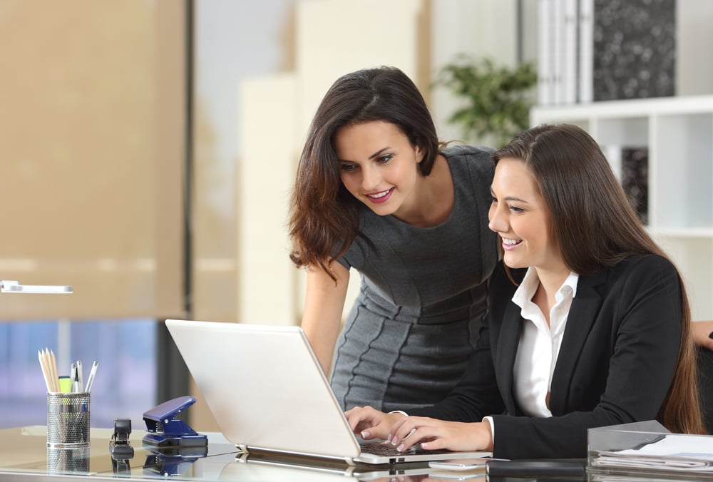 Two-happy-businesswomen-coworking-how-to-praise-someone-professionally