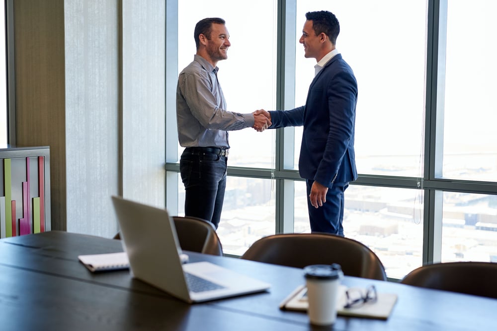 Two-males-skaing-hands-in-office-how-to-network