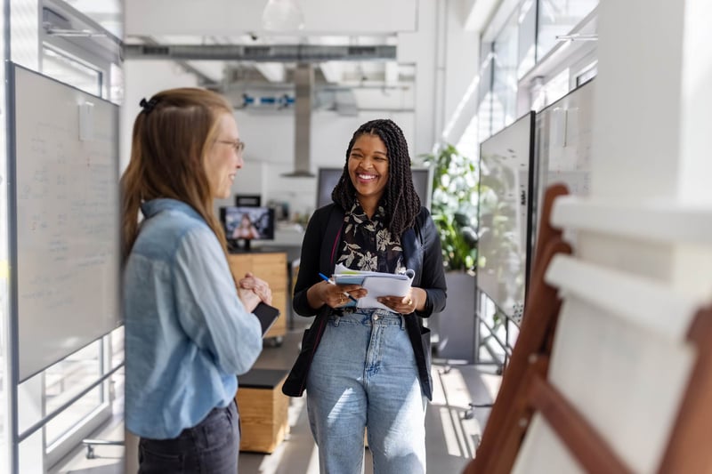 Two-women-smiling-and-talking-how-to-respond-to-a-job-rejection-email