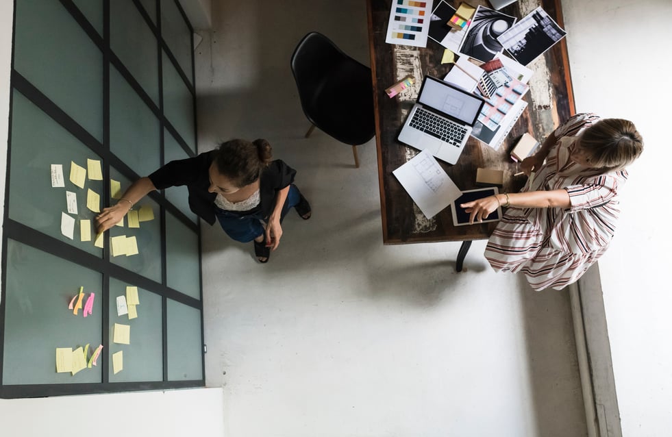 Two-women-working-together-in-office-long-term-vs-short-term-goals