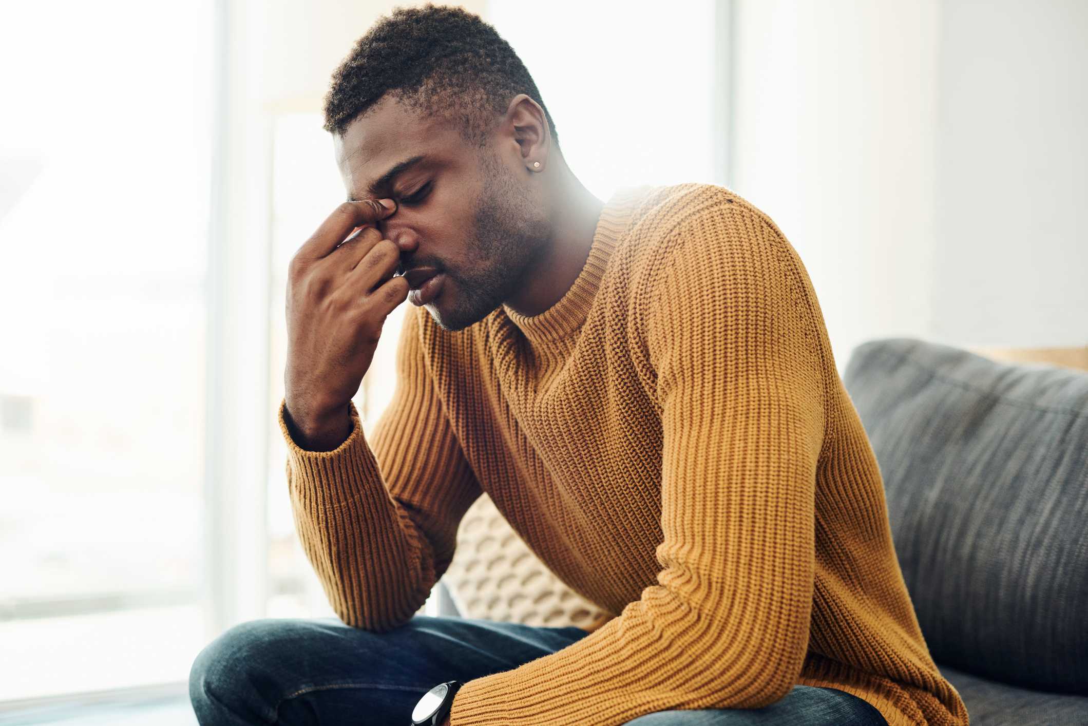 Upset-man-covering-his-face-alone-at-his-house-what-are-the-emotional-triggers-for-empaths