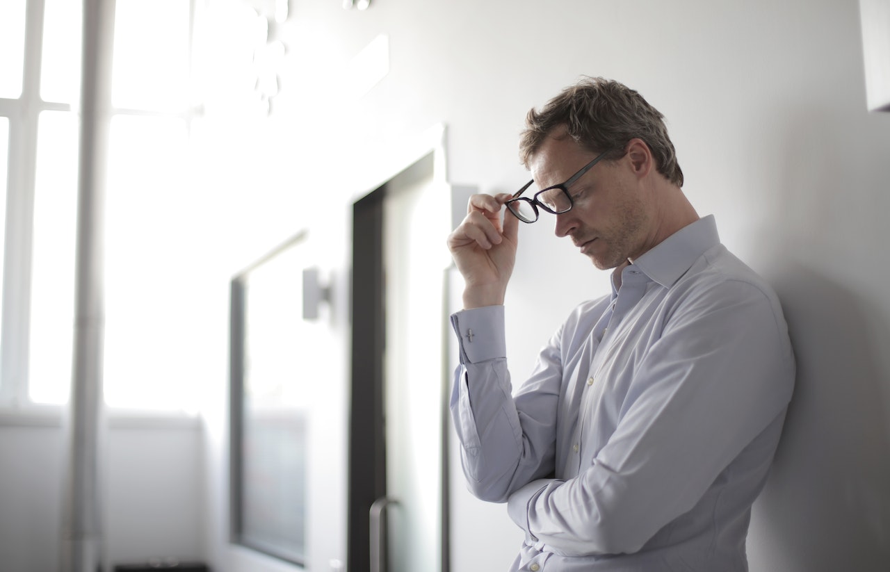 Upset-man-holding-his-glasses-at-office-core-beliefs