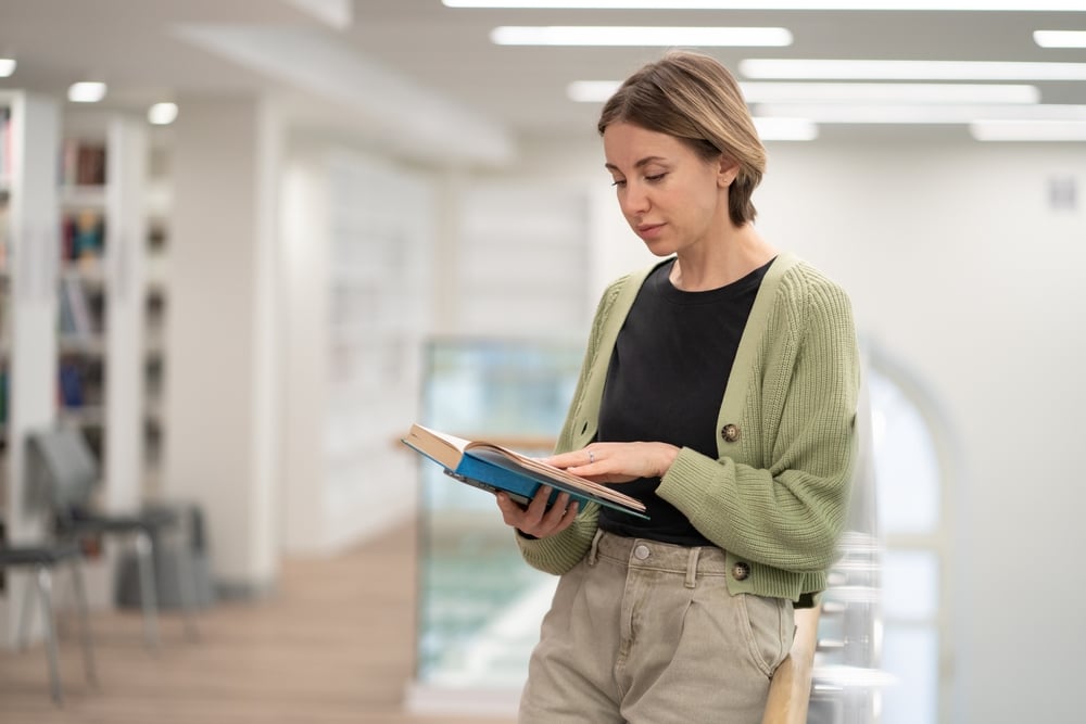 White-woman-reading-standing-concentration-exercises