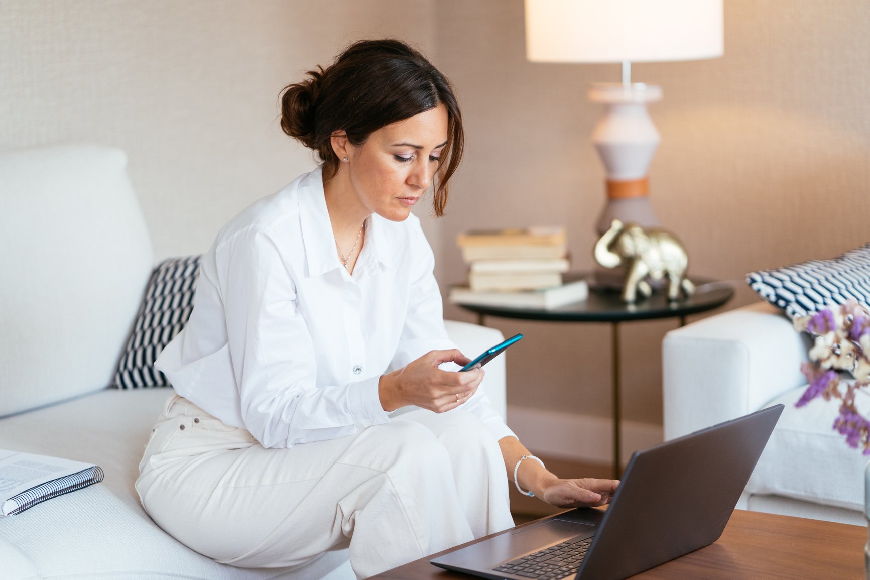 Woman-Checking-Smartphone-During-Work-overqualified-for-job