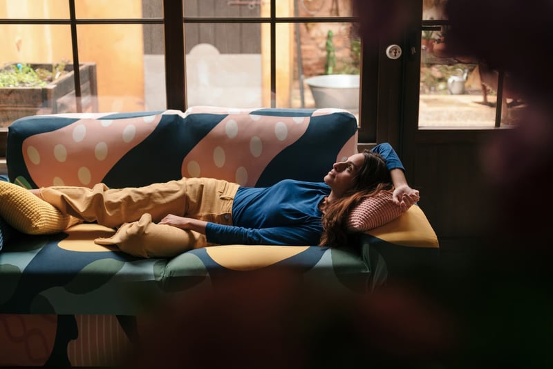 Woman-Lying-On-Sofa-Spending-Time-Alone-At-Home-1