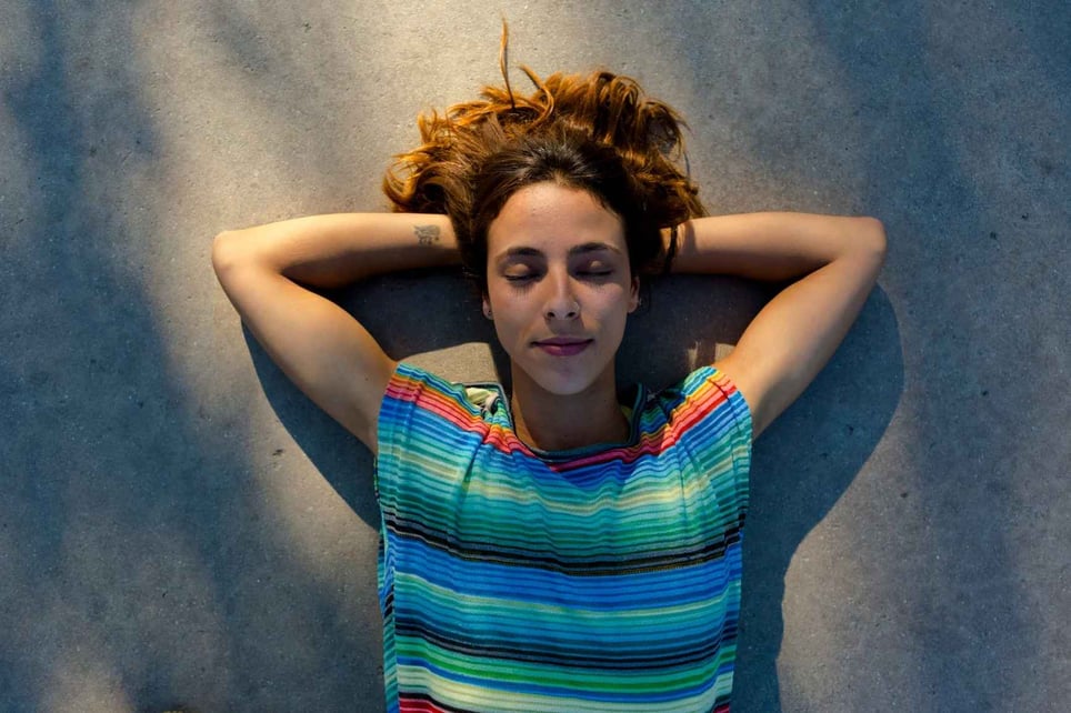 Woman-Relaxing-On-The-Ground-With-Closed-Eyes-how-to-clear-your-mind