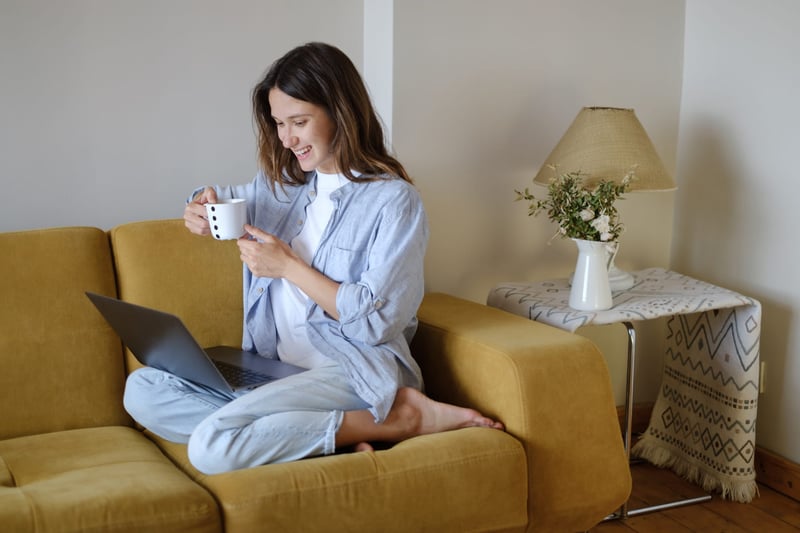 Woman-With-Laptop-Sitting-On-Sofa-1