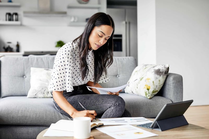 Woman-analyzing-documents-while-sitting-at-home-how-to-focus-on-yourself