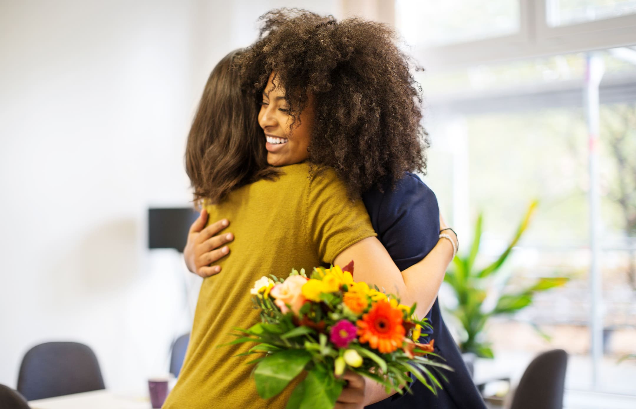 Woman-congratulating-coworker-on-success-how-to-protect-yourself-from-toxic-empathy