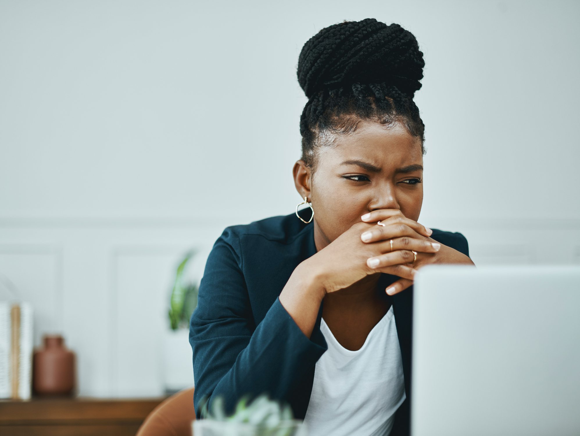 Woman-looking-at-computer-feeling-stressed-and-confused-how-to-stop-self-pity