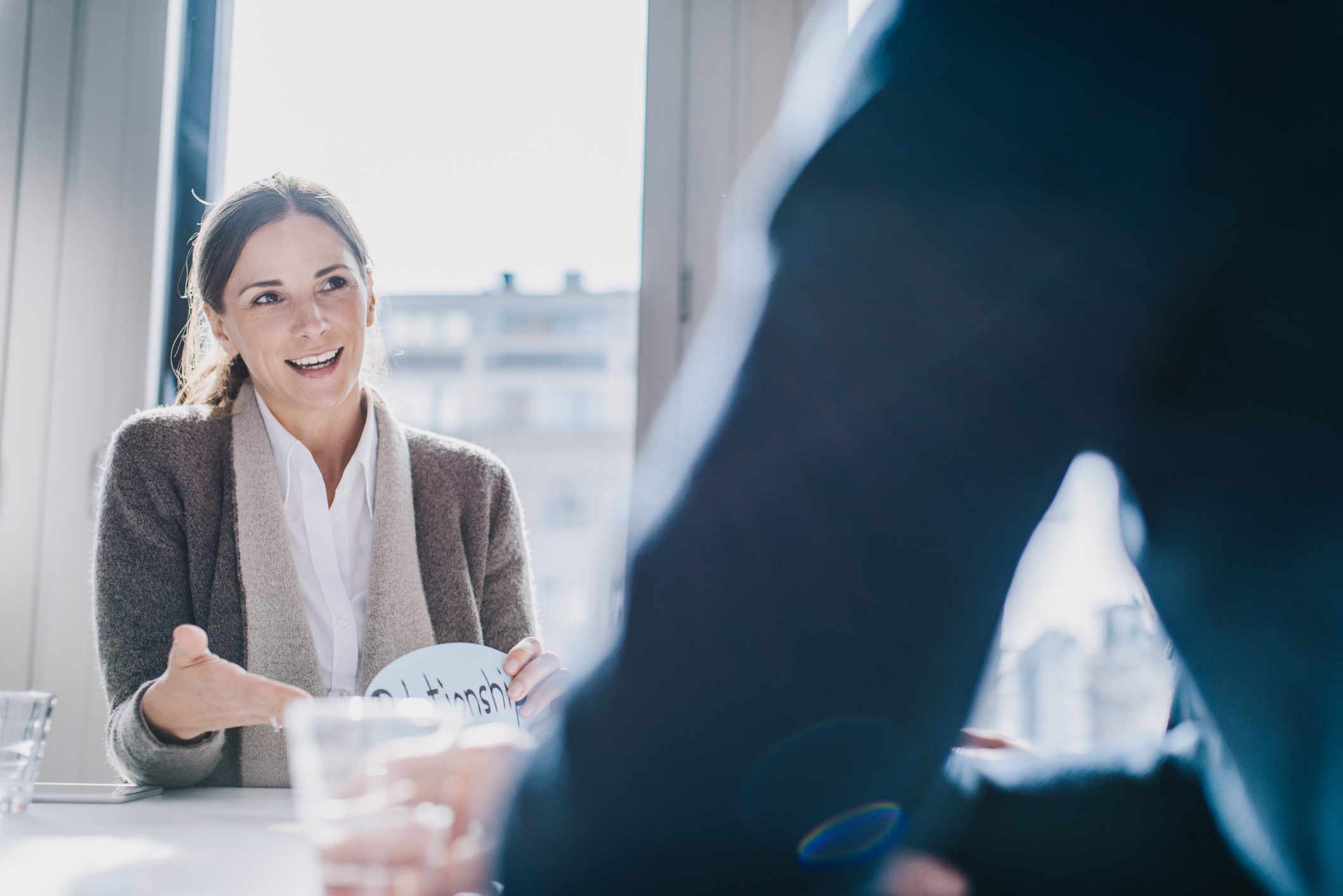 Woman-talking-to-collegue-at-office-examples-of-behavioral-goals