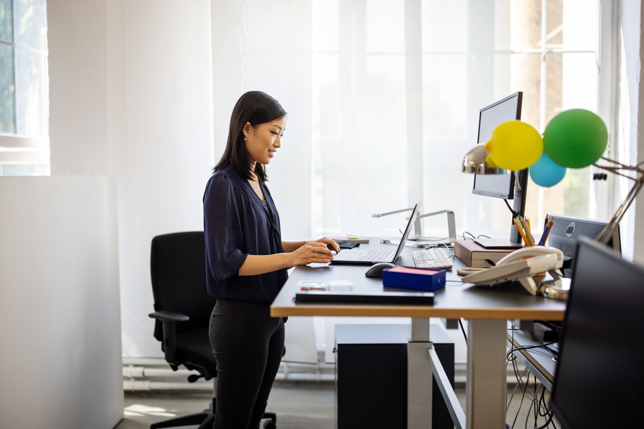 Woman-working-at-standing-desk-employee-health