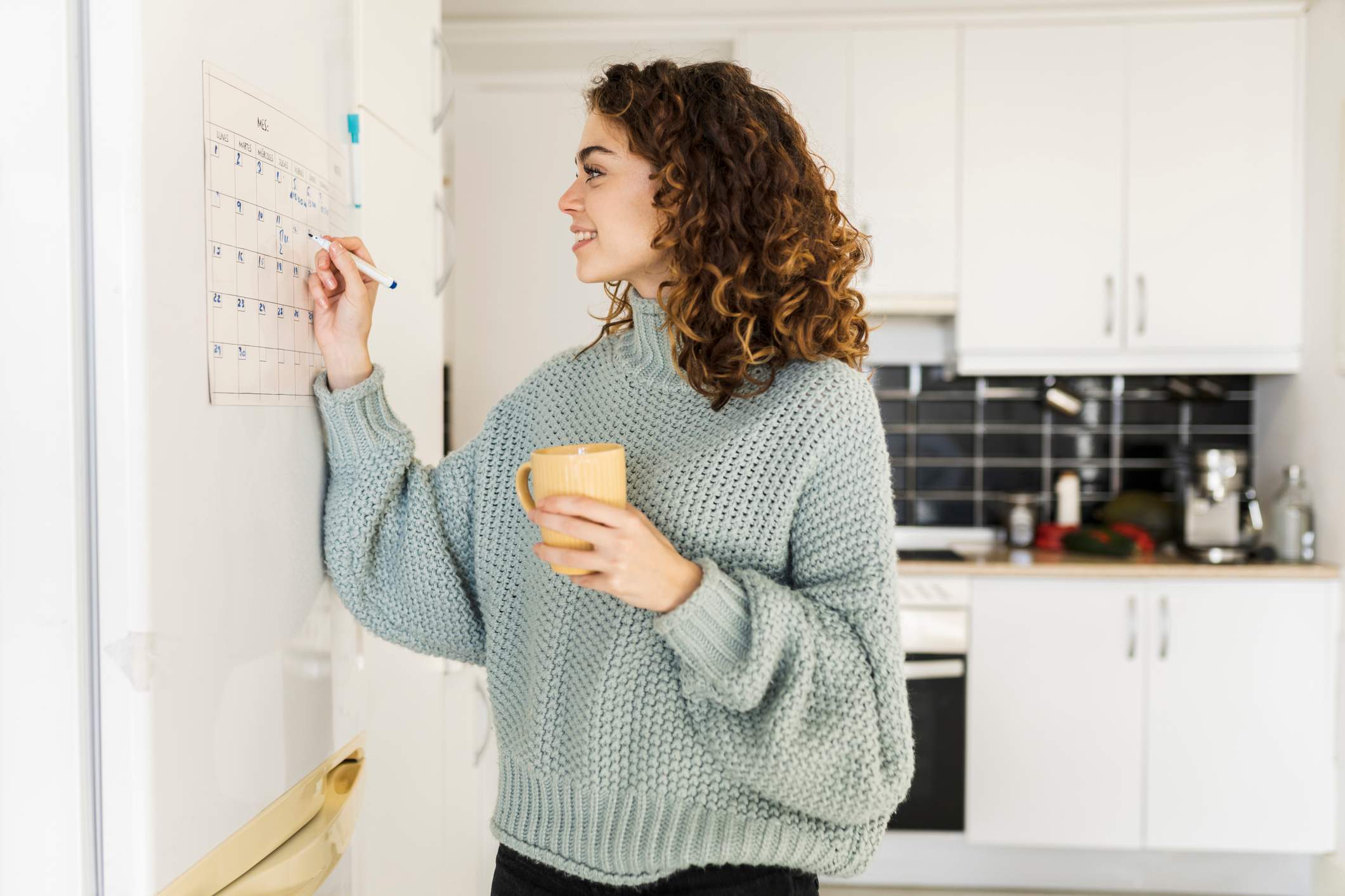 Woman-writing-on-her-schedule-what-to-do-when-you-get-laid-off